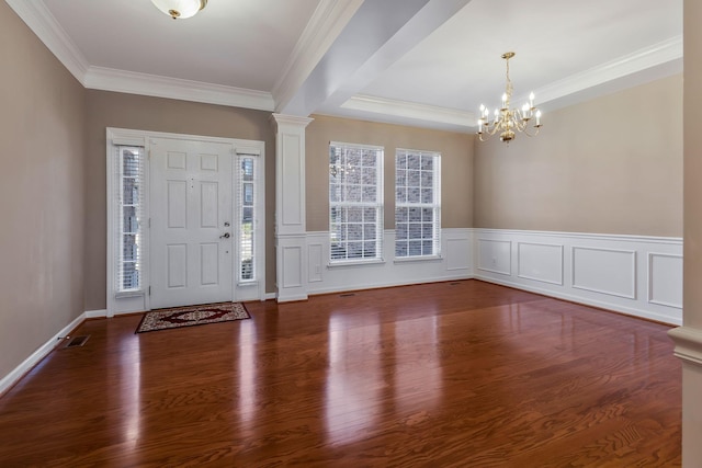 entryway featuring crown molding, decorative columns, a chandelier, and a healthy amount of sunlight