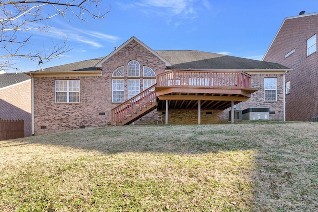 back of property with a wooden deck and a yard