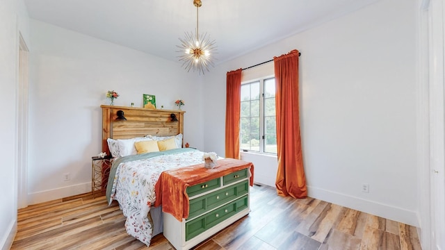 bedroom with wood-type flooring and a notable chandelier