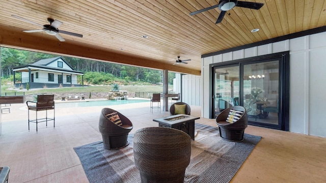 view of patio featuring ceiling fan and a fire pit