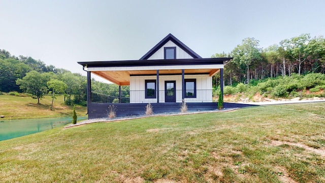 view of front facade featuring a front yard, a water view, and a porch