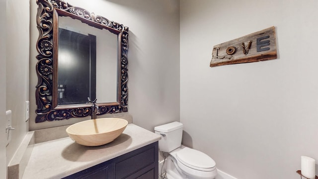 bathroom featuring toilet and vanity