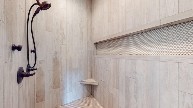 interior details featuring tiled shower