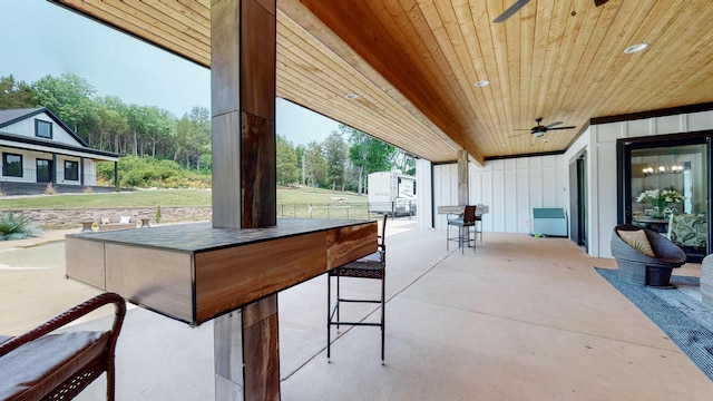 view of patio / terrace with ceiling fan and exterior bar