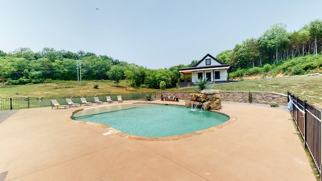 view of pool with a lawn and a patio