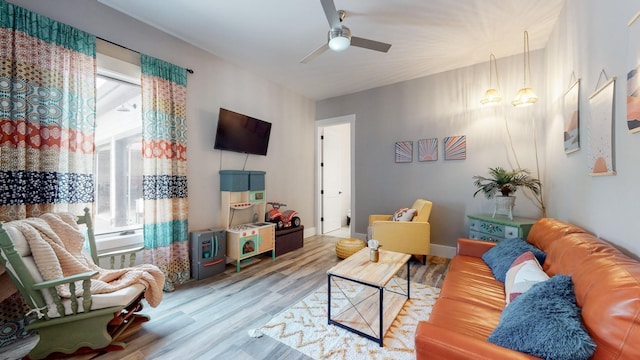 living room featuring hardwood / wood-style flooring and ceiling fan