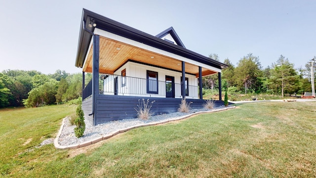 view of property exterior featuring a lawn and a porch