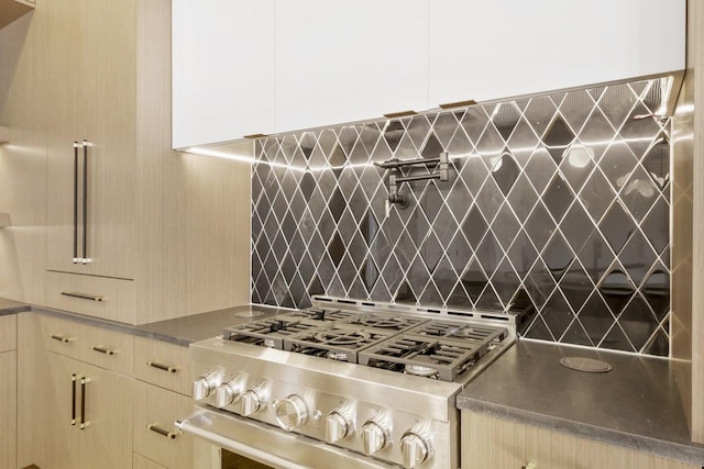 kitchen featuring stainless steel range with gas cooktop and backsplash