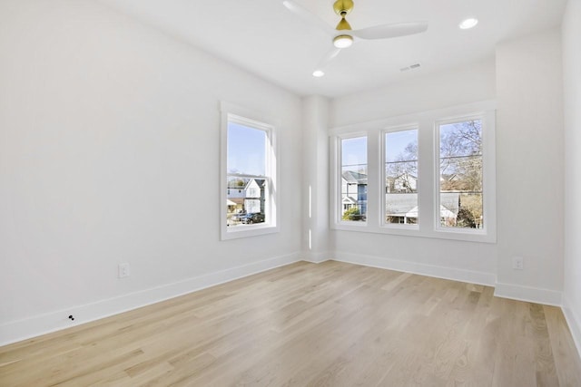 empty room featuring ceiling fan and light hardwood / wood-style floors