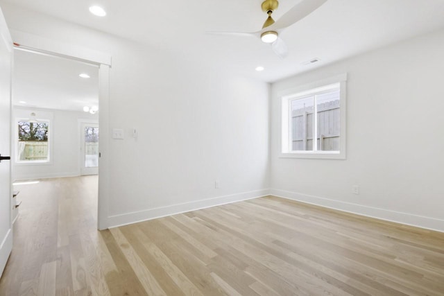 unfurnished room featuring ceiling fan and light wood-type flooring