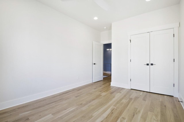 unfurnished bedroom with light hardwood / wood-style floors and a closet