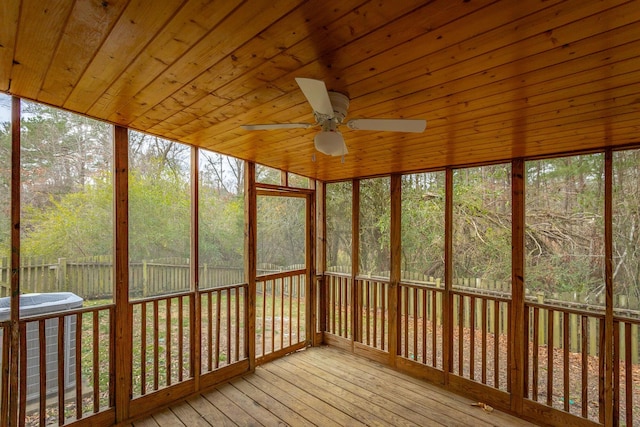 unfurnished sunroom with wooden ceiling and ceiling fan