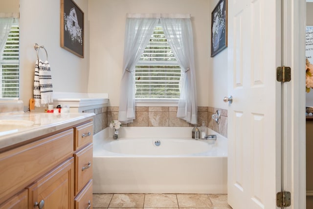 bathroom featuring a bath, tile patterned flooring, and vanity