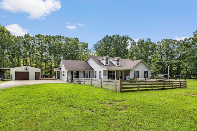 new england style home featuring a garage, a front yard, and an outbuilding