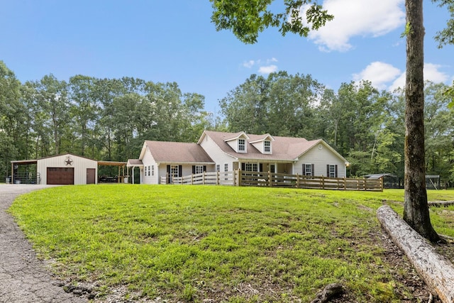 cape cod home featuring a garage, an outbuilding, a front yard, and a carport