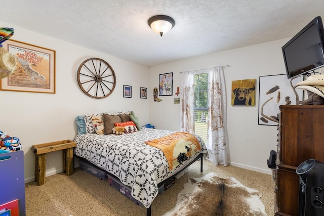 bedroom with a textured ceiling and light colored carpet