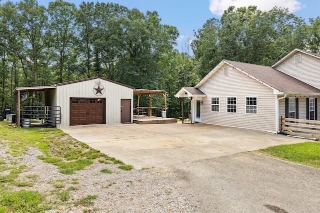 view of property exterior with a garage and an outdoor structure