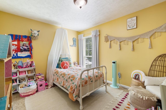 bedroom featuring a textured ceiling and carpet floors