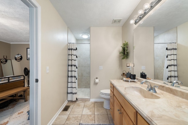 bathroom featuring toilet, a textured ceiling, walk in shower, tile patterned floors, and vanity