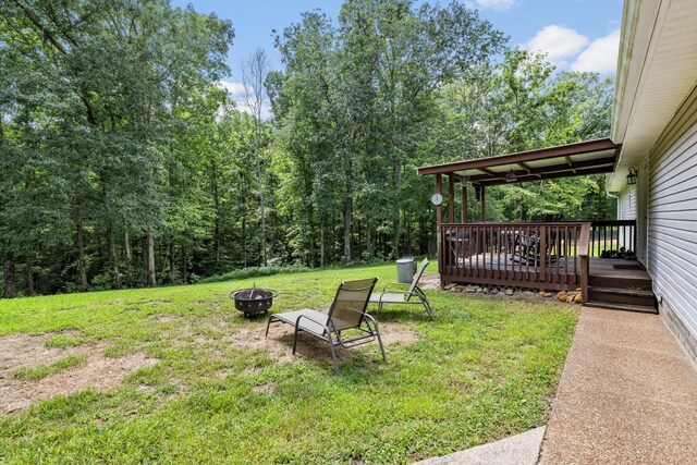 view of yard with a fire pit and a wooden deck