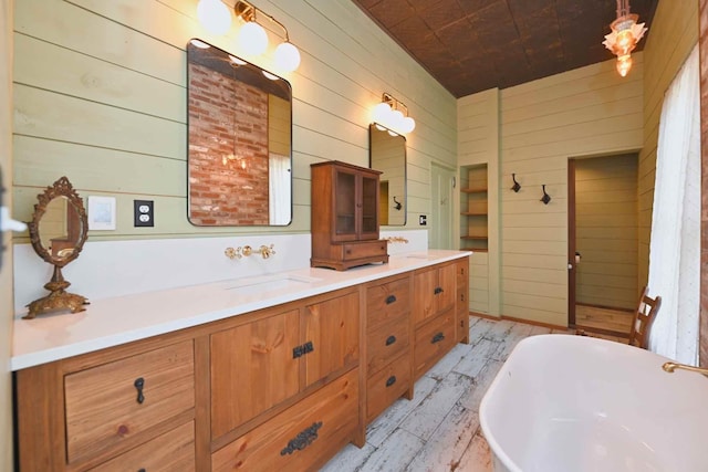 bathroom featuring vanity, wood walls, and a bathing tub