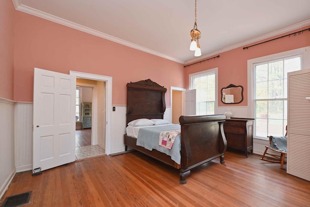 bedroom featuring hardwood / wood-style floors and ornamental molding