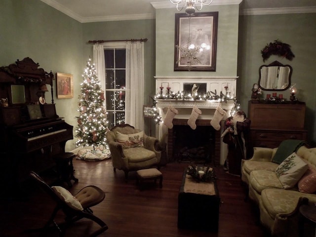 sitting room featuring an inviting chandelier, a brick fireplace, ornamental molding, and dark hardwood / wood-style flooring