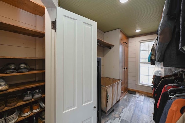 mudroom featuring wooden walls and light wood-type flooring