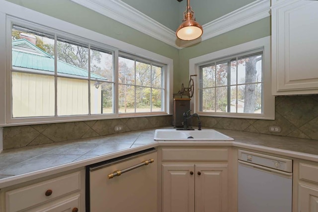 kitchen with sink, white cabinetry, pendant lighting, and tasteful backsplash