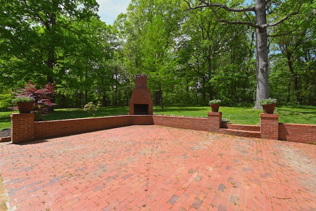 view of patio with an outdoor brick fireplace