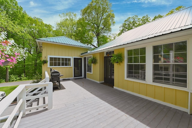 wooden deck featuring a grill