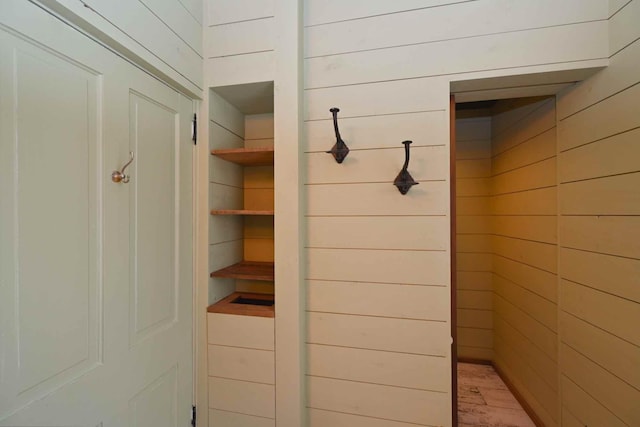 mudroom featuring wood walls