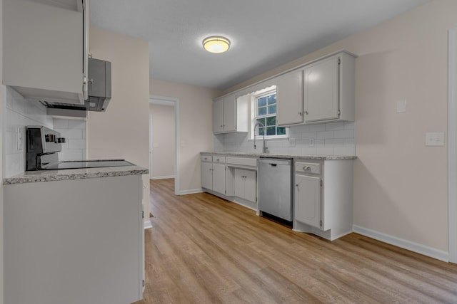 kitchen featuring stove, backsplash, white cabinetry, and dishwasher