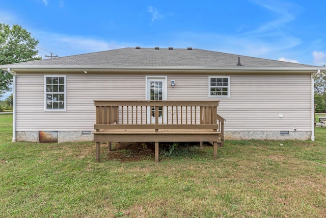 rear view of property with a lawn and a wooden deck