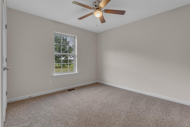 carpeted spare room featuring ceiling fan