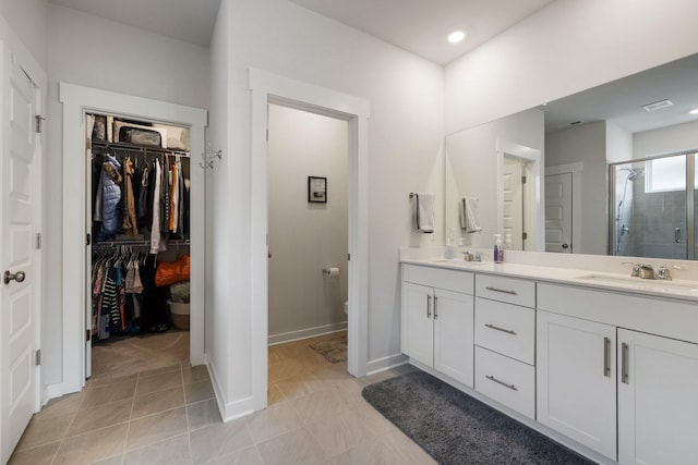 bathroom with vanity, an enclosed shower, and tile patterned flooring