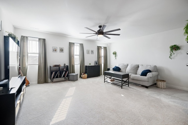 living room with ceiling fan and light colored carpet