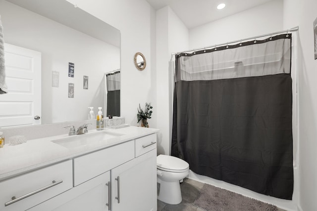 bathroom featuring vanity, toilet, and walk in shower