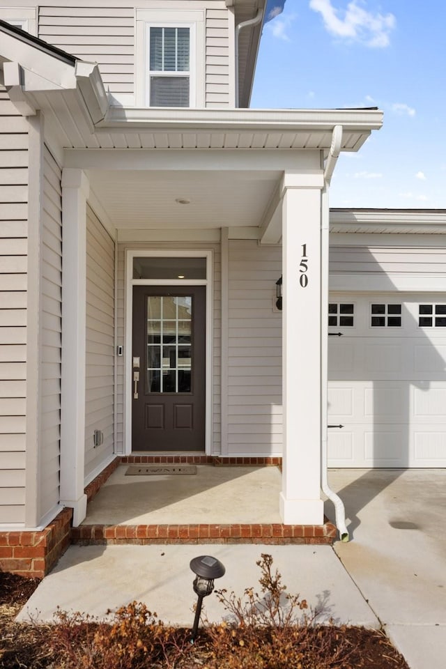 property entrance with a garage and a porch