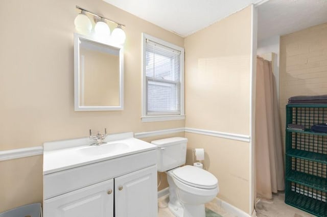 bathroom featuring vanity, toilet, and a shower with curtain