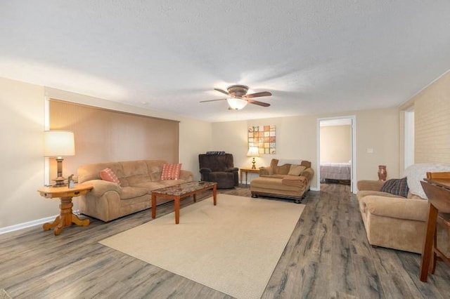 living room with hardwood / wood-style flooring and ceiling fan