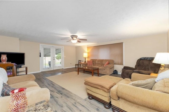 living room with ceiling fan, hardwood / wood-style floors, and french doors