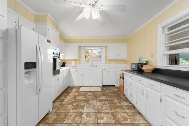 kitchen featuring white cabinets, white appliances, ornamental molding, and sink