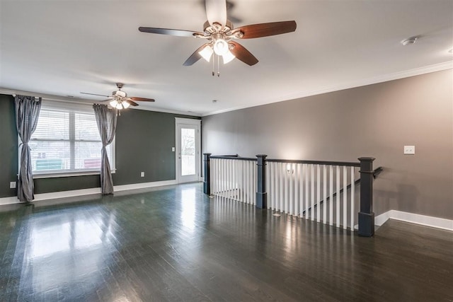 spare room featuring plenty of natural light, dark hardwood / wood-style flooring, and ornamental molding