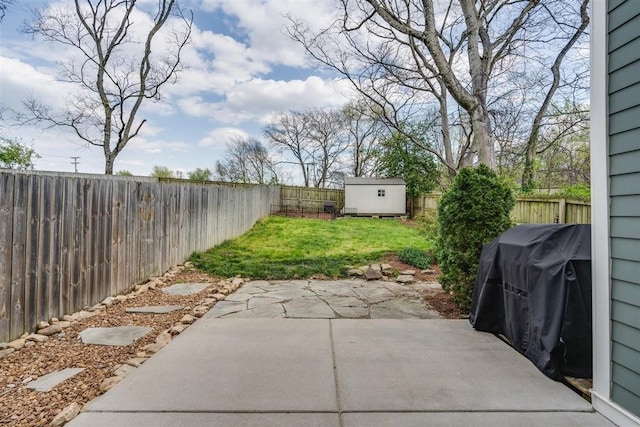 view of patio / terrace featuring a storage shed and a grill