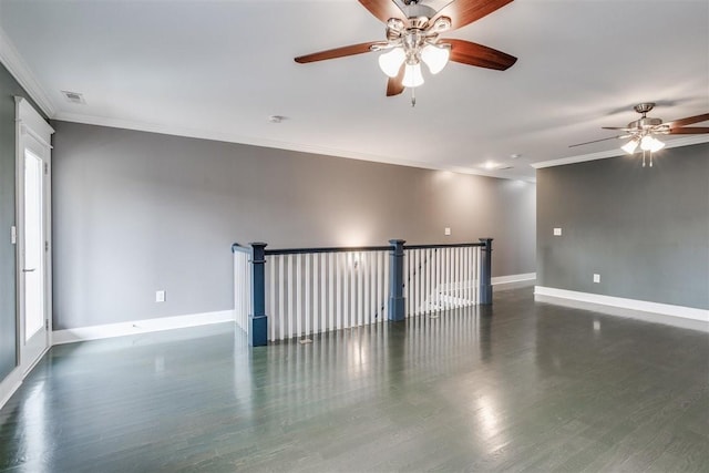 unfurnished room featuring dark wood-type flooring, a wealth of natural light, and crown molding