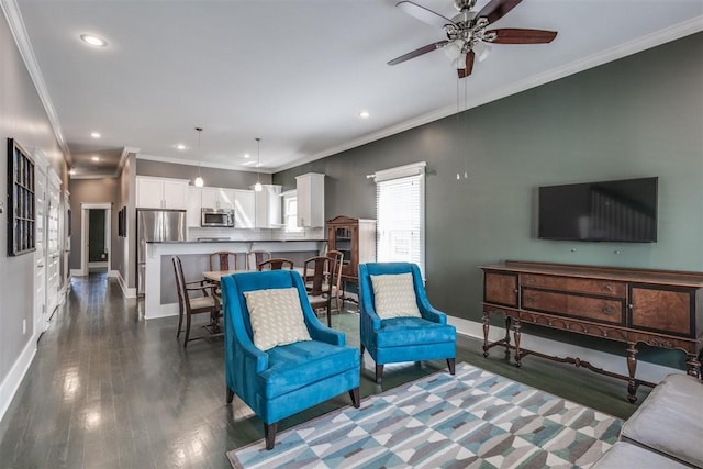 living room with ceiling fan, ornamental molding, and dark hardwood / wood-style floors