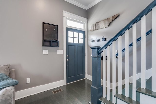 foyer featuring ornamental molding and dark hardwood / wood-style flooring