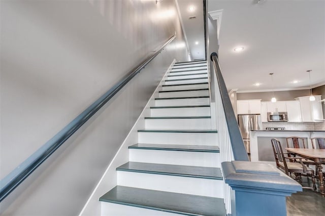 staircase featuring crown molding