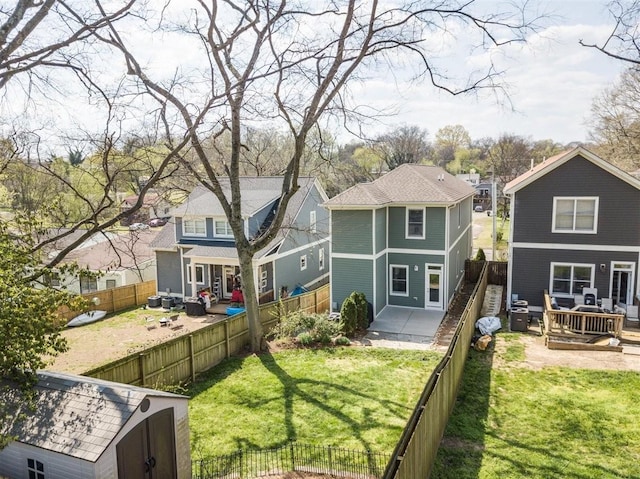 back of property with an outdoor living space, a patio, a lawn, and a storage unit